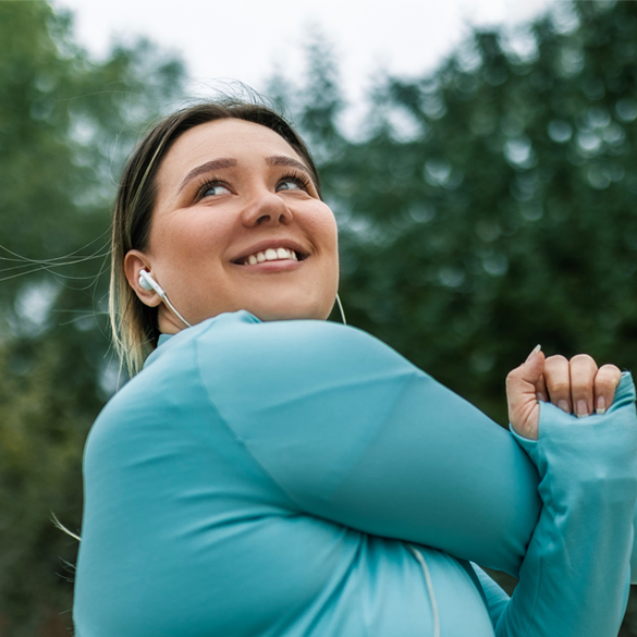 Smiling women stretching her arm.